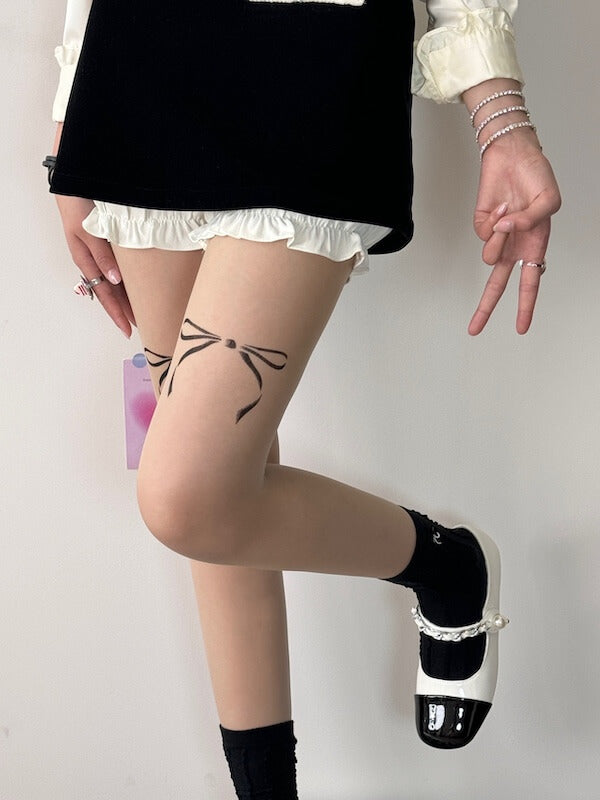 Dollette bow tattoo tights